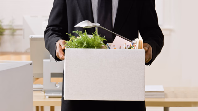 a professional boxing up his office belongings after leaving his job