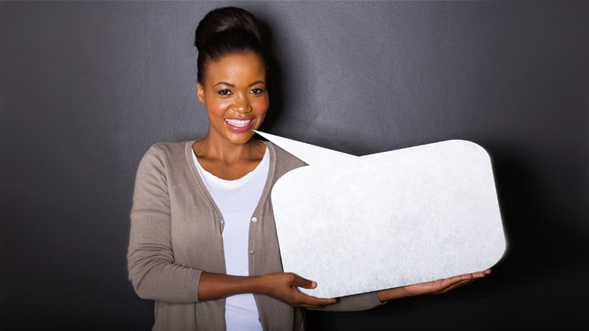 woman holding speech bubble sign