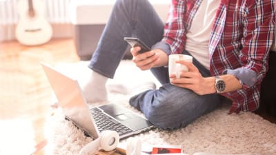 job seeker checking phone and laptop