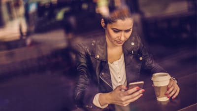 woman using a networking app on her phone