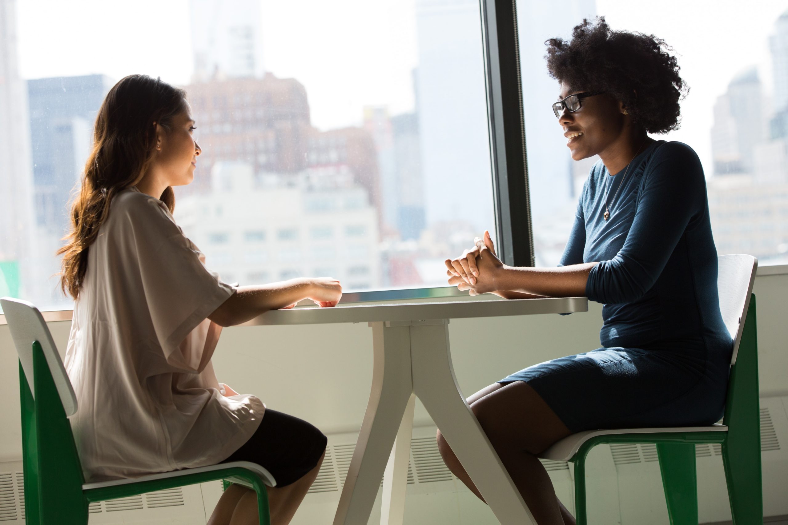 Two women in conversation at a table